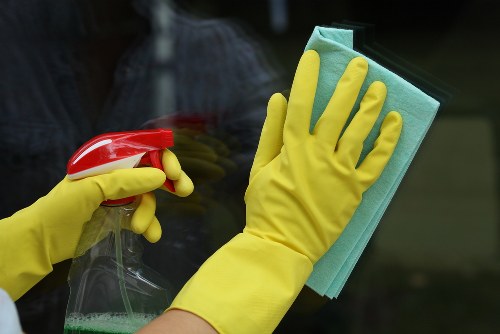 Operative putting on protective gloves before cleaning